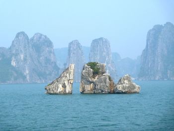 Scenic view of sea and mountains against sky