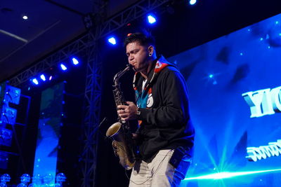 Low angle view of man standing at music concert