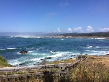 Scenic view of beach against blue sky