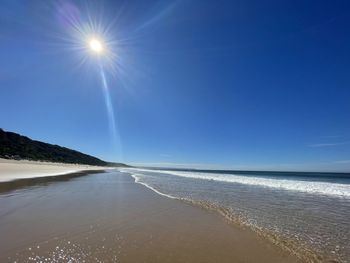 Scenic view of sea against sky on sunny day