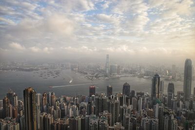 View of cityscape against cloudy sky