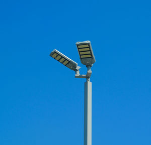 Low angle view of street light against clear blue sky