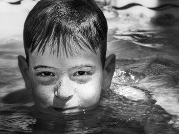 Portrait of boy swimming in pool