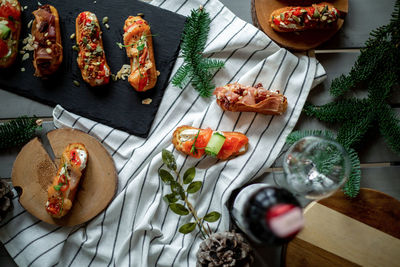 Eclairs with salmon, fresh vegetables and herbs, gourmet snacks.