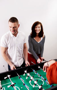 Friends playing foosball