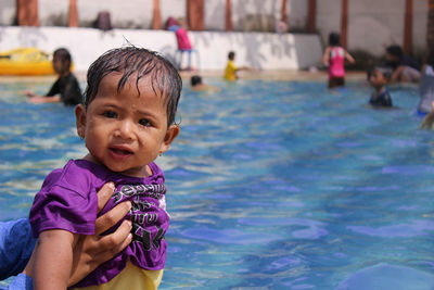 Portrait of cute girl playing in pool