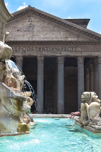 Fountain in swimming pool against sky