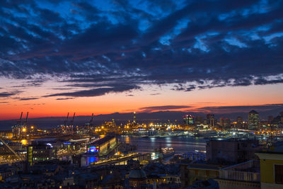 High angle view of illuminated buildings against sky at sunset