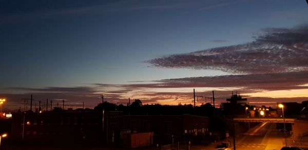 Silhouette buildings against sky at sunset