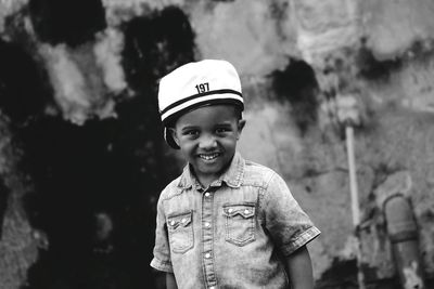 Portrait of smiling boy standing outdoors