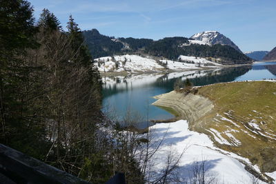 Scenic view of lake against sky during winter