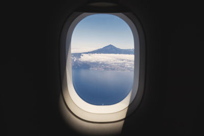 Aerial view from airplane window. volcano teide on tenerife at sunny day, spain.