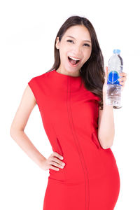 Portrait of a smiling young woman against white background