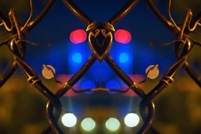 Close-up of illuminated lights at fence