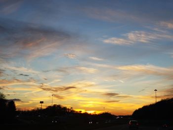 Silhouette city against sky during sunset