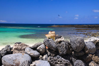 Rocks on beach against sky