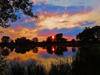 Scenic view of lake against sky during sunset