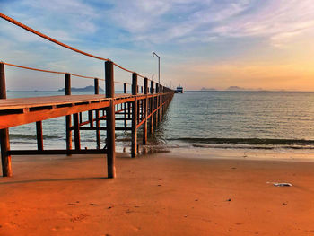 Scenic view of beach against cloudy sky