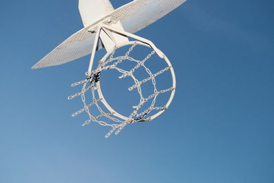 Low angle view of basketball hoop against blue sky
