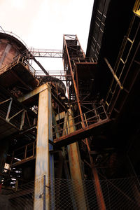 Low angle view of abandoned building against sky