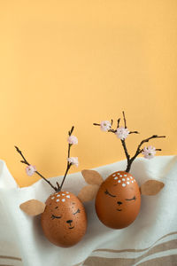 Funny deers made of eggs on fabric background. brown easter eggs. space for your text. 