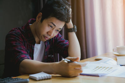 Stressed businessman working at desk in office