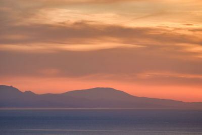 Scenic view of sea against romantic sky at sunset
