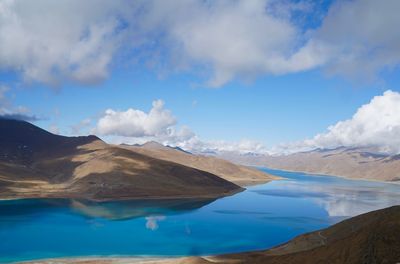 Scenic view of lake and mountains against sky