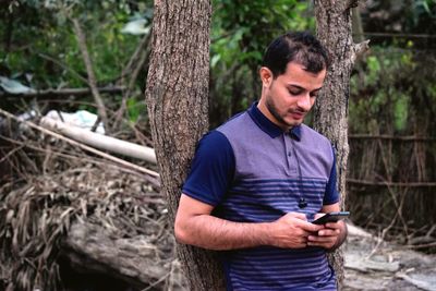 Man using smart phone outdoors