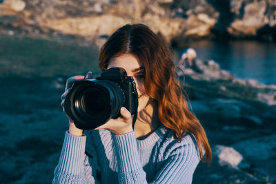 Portrait of woman photographing camera