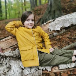 Portrait of smiling girl sitting on wood