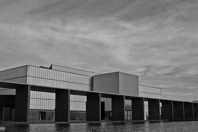 Low angle view of building by sea against sky