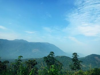 Scenic view of mountains against blue sky