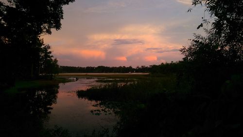 Scenic view of lake at sunset