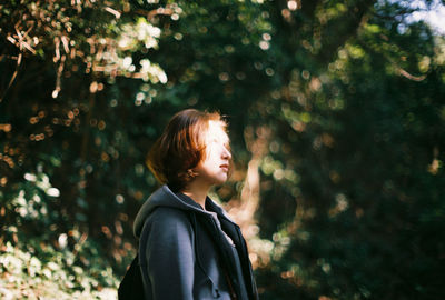 Young woman standing in park