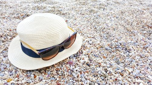 Close-up of hat on sand at beach