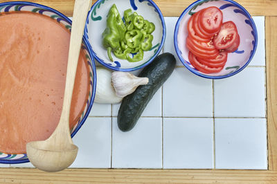Gazpacho, andalusian and some ingredient to prepare it, such as tomato, garlic and onion, cucumber, 