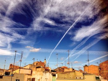 Low angle view of houses against cloudy sky