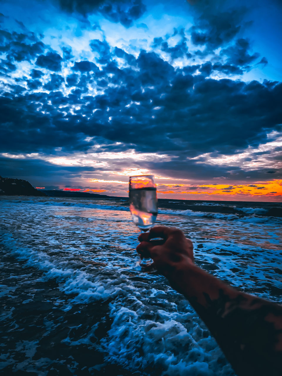 MAN HOLDING GLASS OF WATER