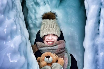 Portrait of smiling boy in snow during winter