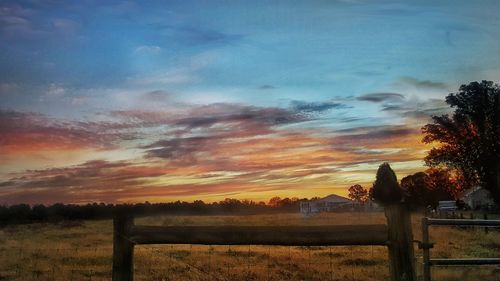 Scenic view of field against sky during sunset