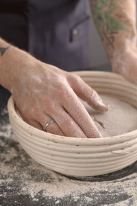 Close-up of man preparing food in bowl