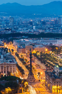 High angle view of city lit up at night