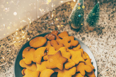 Glistening ginger cookies arranged on plate, nestled against the enchanting glow of new years lights