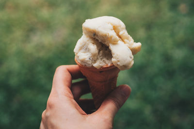 Close-up of hand holding ice cream cone