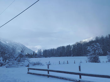 Snow covered landscape against sky