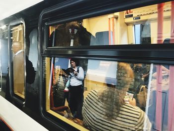 Woman standing by window at store