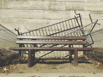 Empty bench against wall