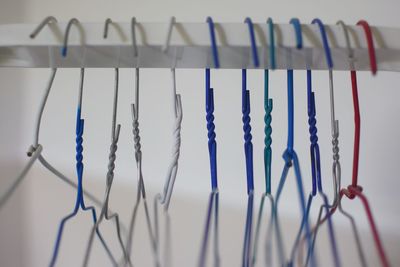 Low angle view of clothespins hanging on rope