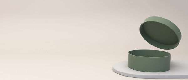 Close-up of empty coffee cup on table against white background
